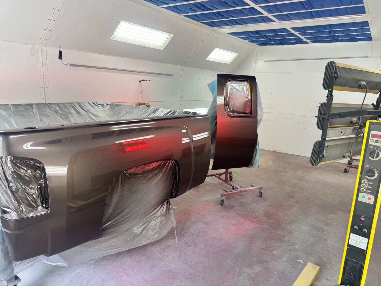 Truck box side and detached door in paint booth
